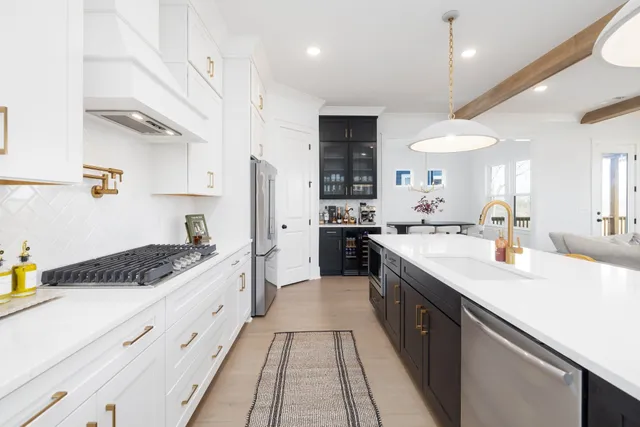 a kitchen with granite countertop white cabinets white stainless steel appliances and sink