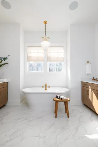 a spacious bedroom with a bed a couch and lots of cabinet