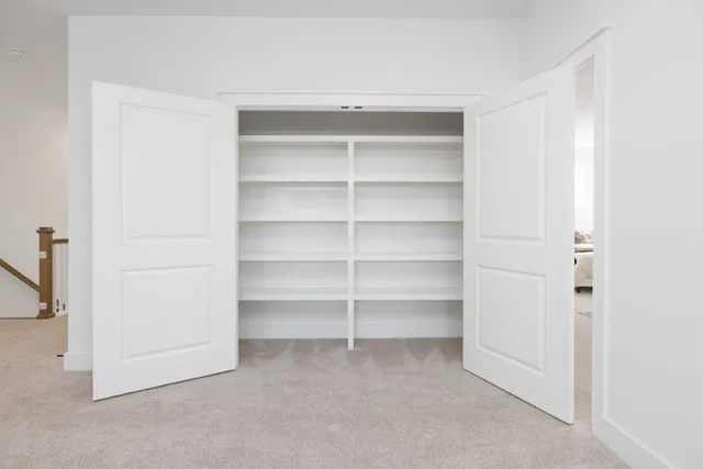 a view of a patio with table and chairs