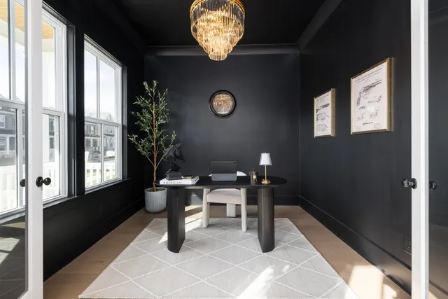 a living room with furniture and kitchen view