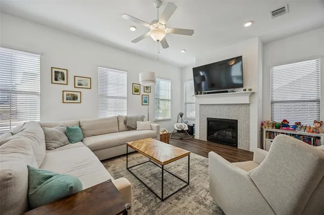 a living room with furniture a flat screen tv and a fireplace