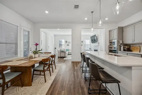 a large dining space with furniture and wooden floor