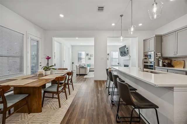 a large dining space with furniture and wooden floor