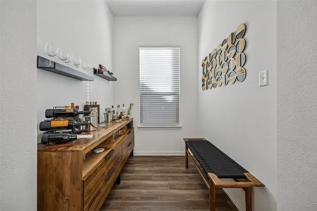 a kitchen with a stove and a wooden floor