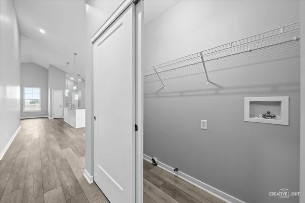 a view of hallway with wooden floor