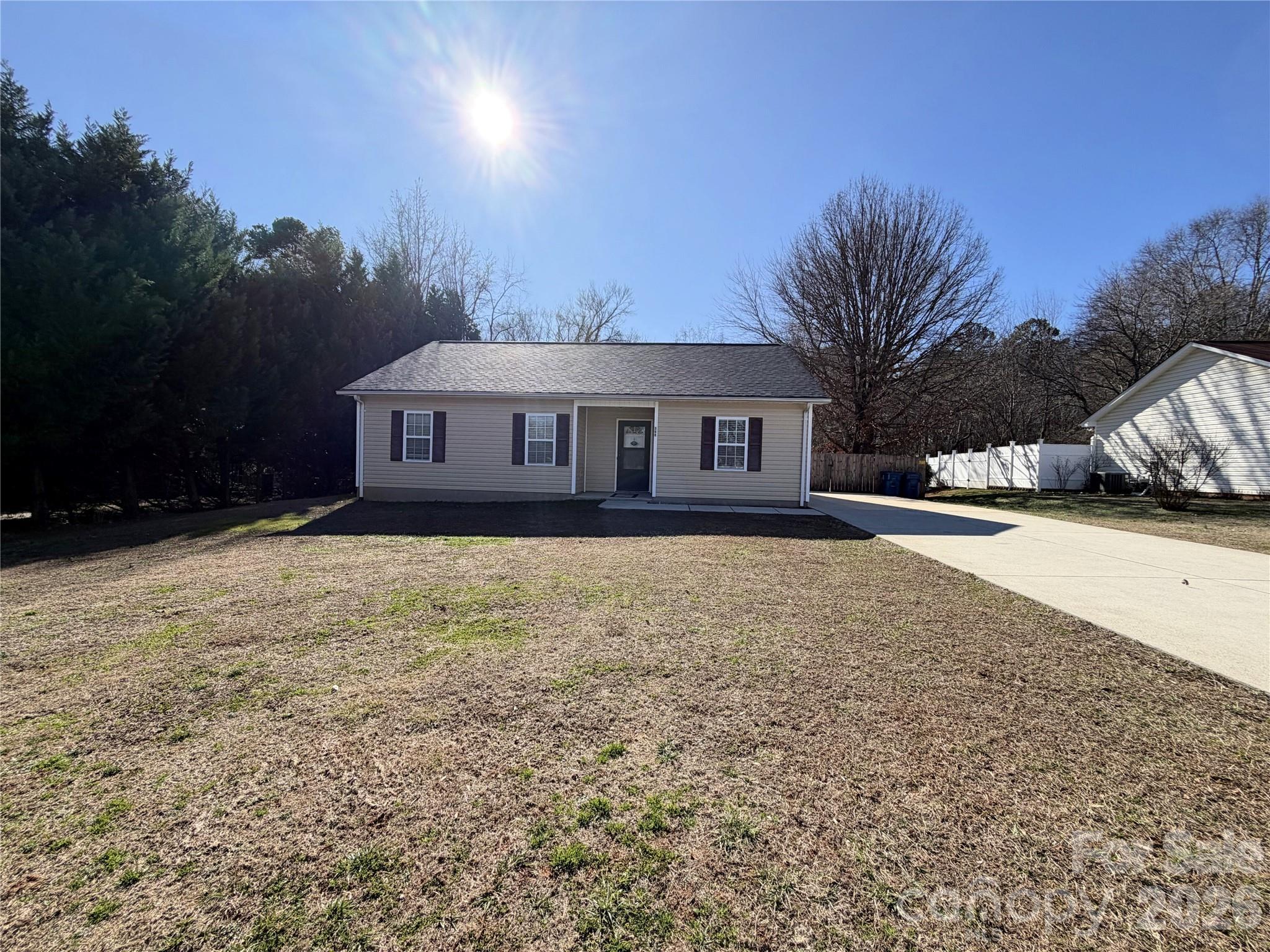 a front view of a house with a yard and trees