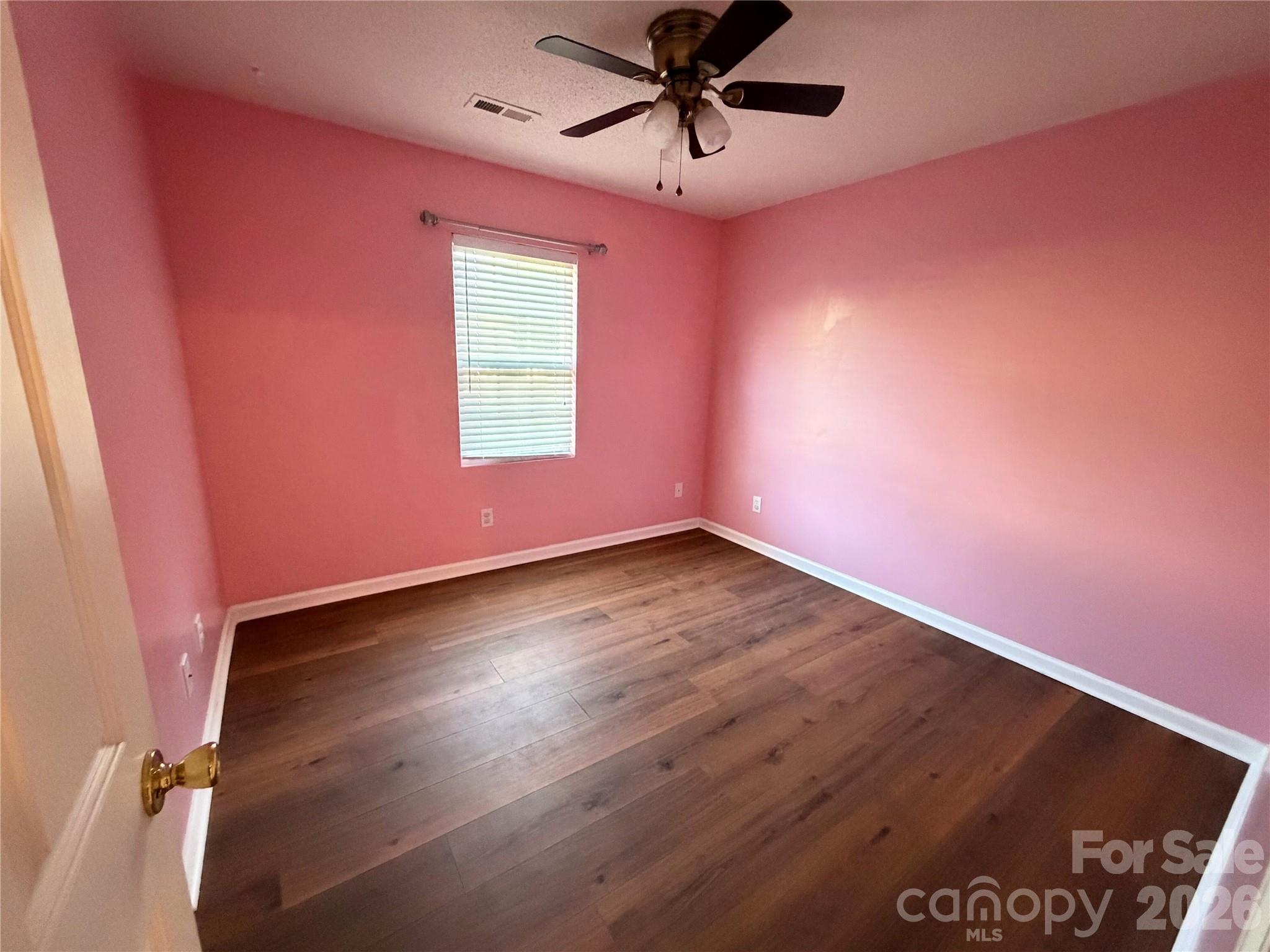 308 Springhill Lane Maiden, NC 28650 - Photo 11 of 21 an empty room with wooden floor and windows