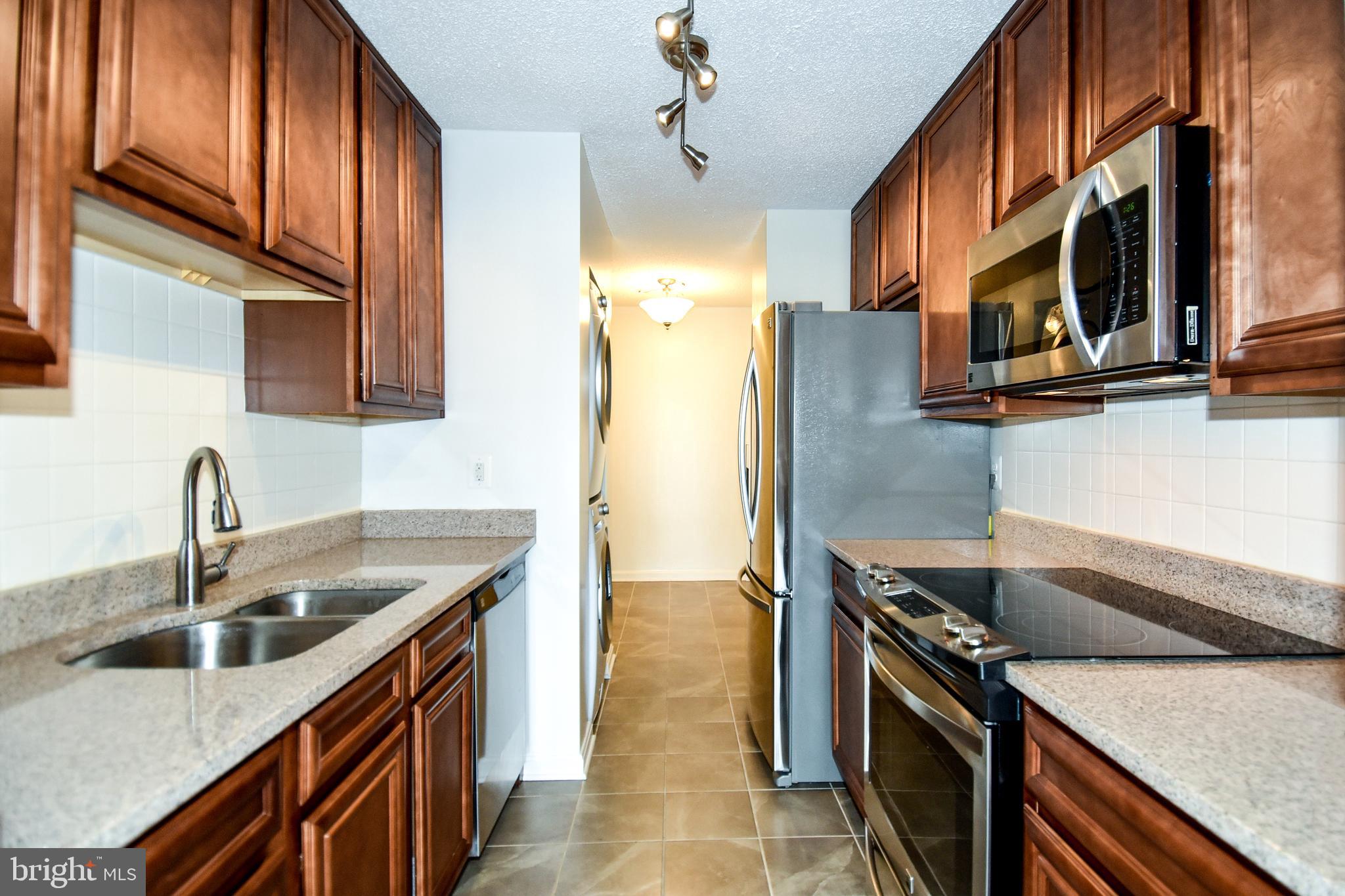 6101 Edsall Road, Unit 1706 Alexandria, VA 22304 - Photo 12 of 40 a kitchen with stainless steel appliances granite countertop a sink a stove and a refrigerator