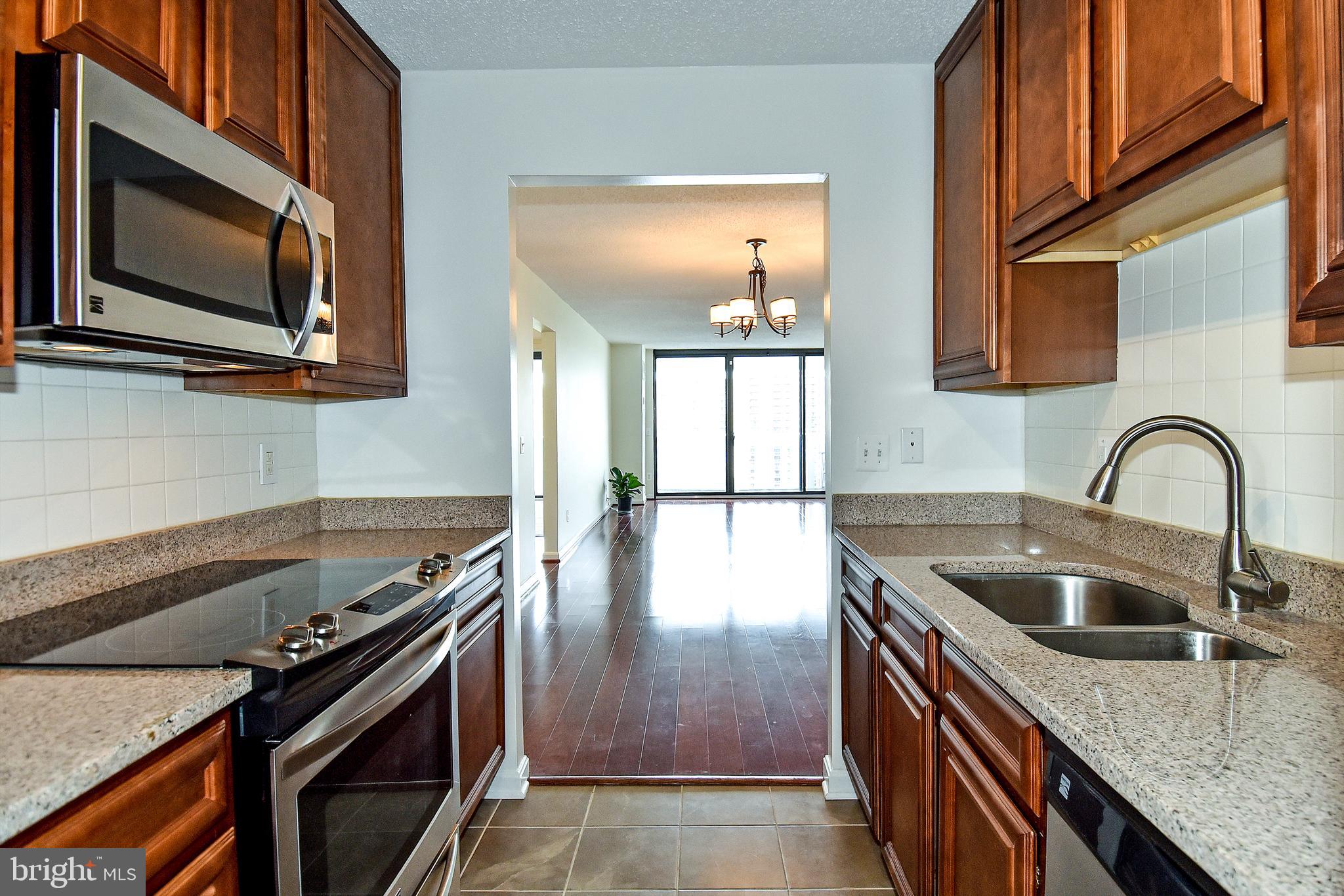 6101 Edsall Road, Unit 1706 Alexandria, VA 22304 - Photo 14 of 40 a kitchen with granite countertop a stove and a sink