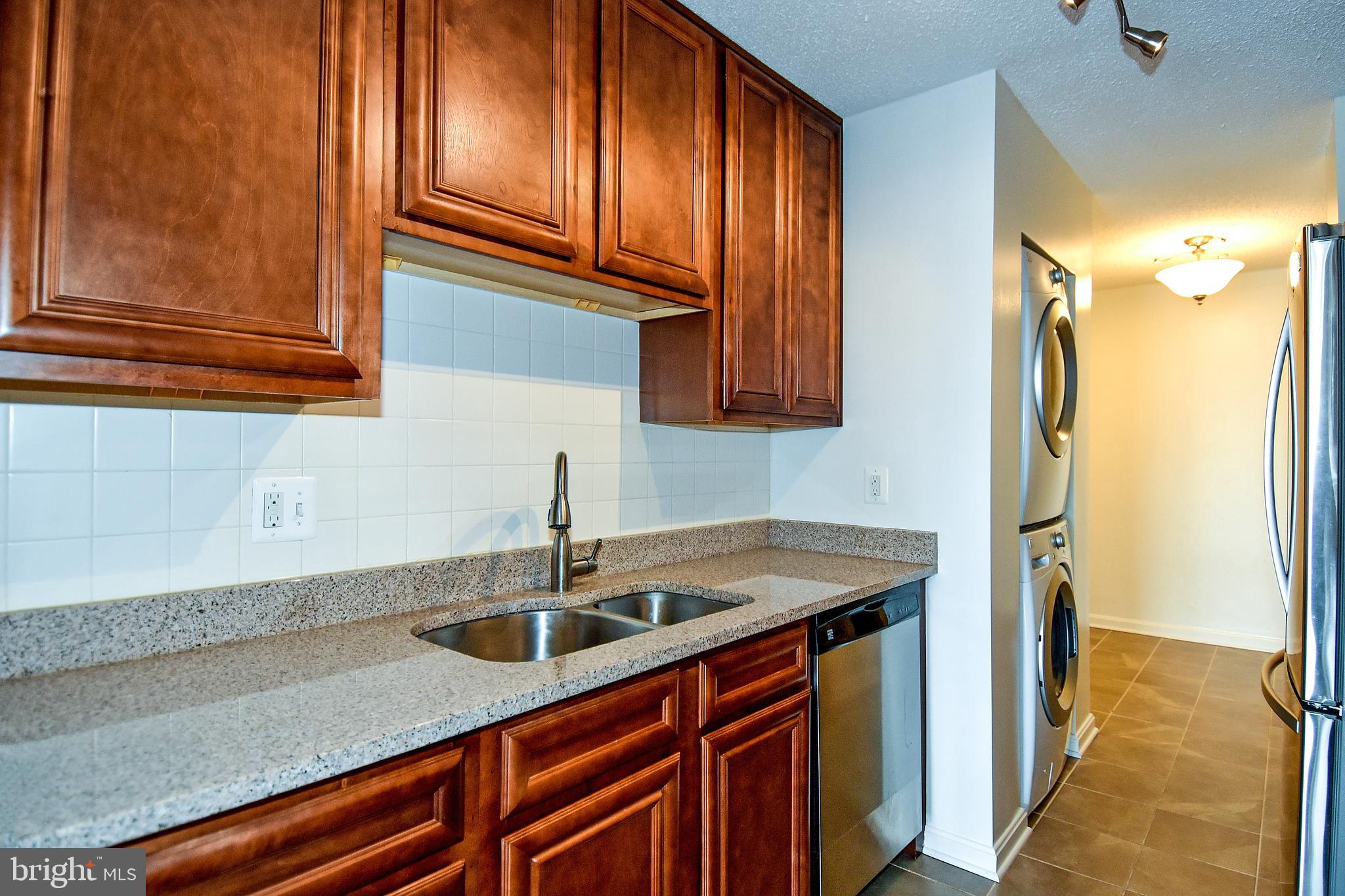 6101 Edsall Road, Unit 1706 Alexandria, VA 22304 - Photo 3 of 40 a kitchen with stainless steel appliances granite countertop a sink and cabinets