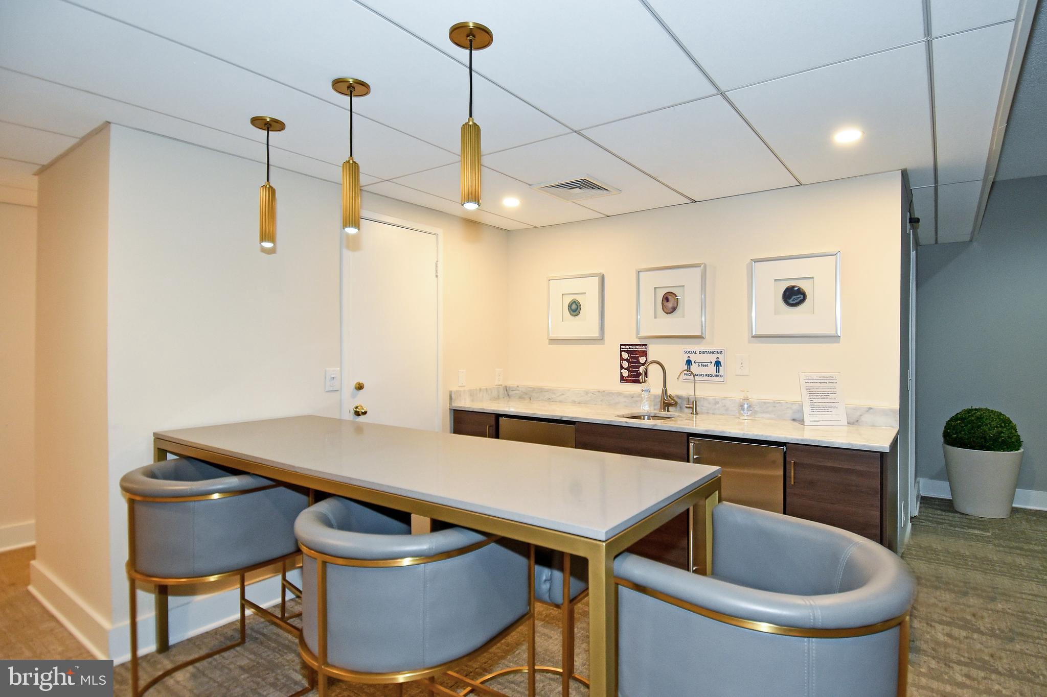 6101 Edsall Road, Unit 1706 Alexandria, VA 22304 - Photo 37 of 40 a kitchen with a table chairs sink and cabinets