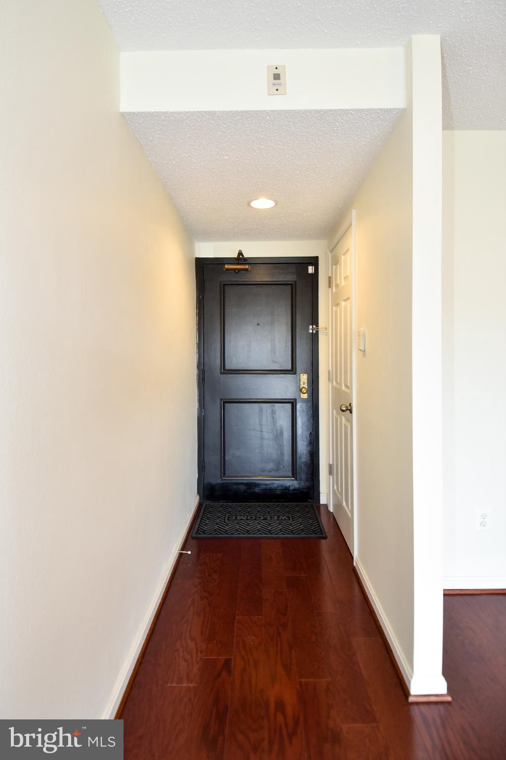 6101 Edsall Road, Unit 1706 Alexandria, VA 22304 - Photo 6 of 40 a view of a hallway with wooden floor