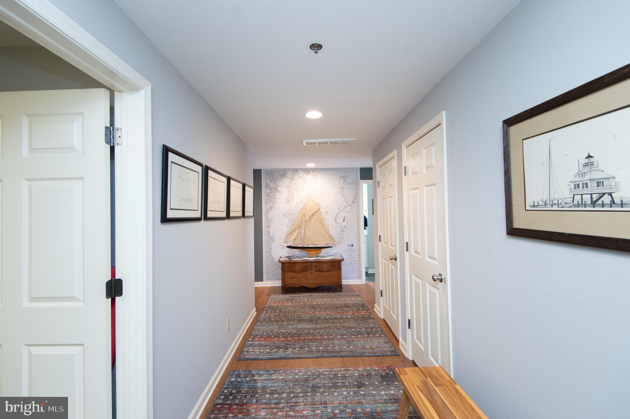 304 Academy Street, Unit 101 Cambridge, MD 21613 - Photo 11 of 56 a view of a hallway with wooden floor and windows
