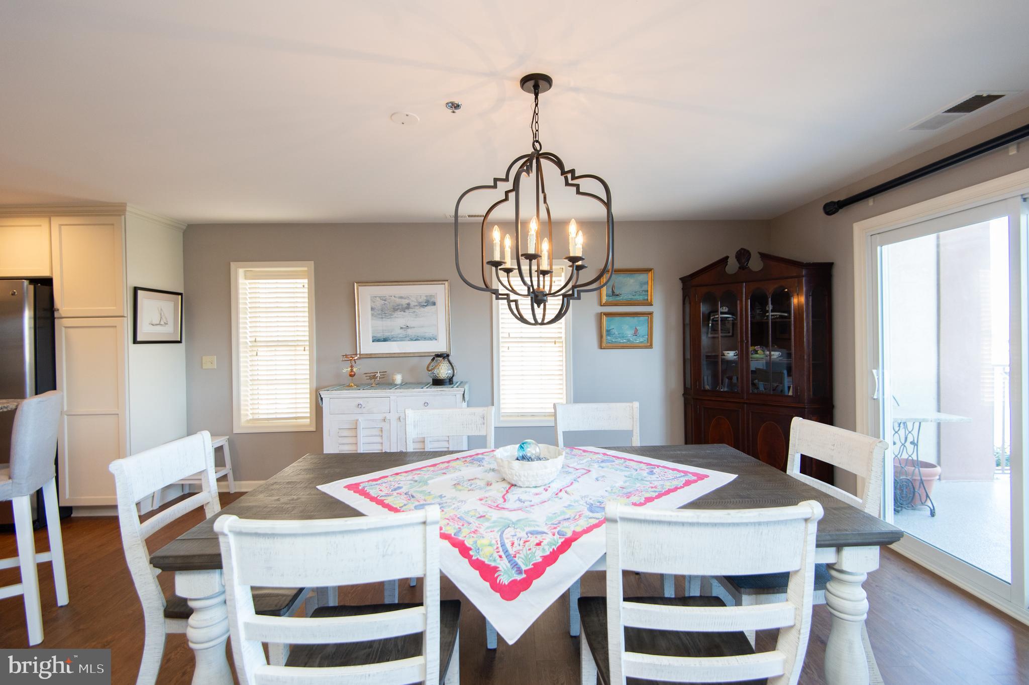 304 Academy Street, Unit 101 Cambridge, MD 21613 - Photo 23 of 56 a view of a dining room with furniture and wooden floor