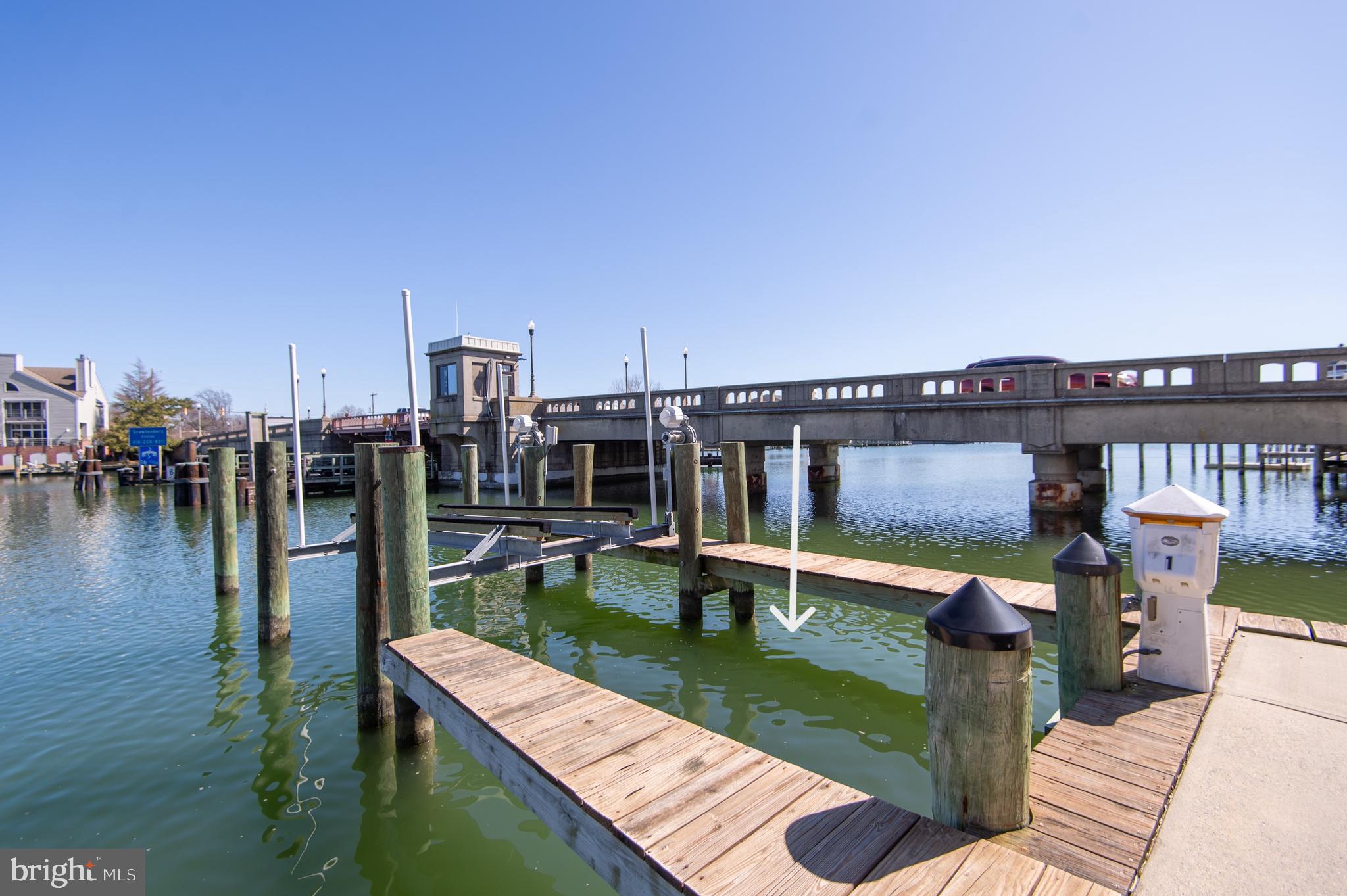 304 Academy Street, Unit 101 Cambridge, MD 21613 - Photo 8 of 56 a view of a balcony with chairs and wooden floor
