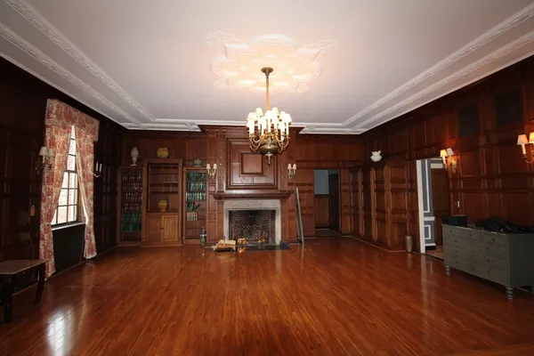 a view of a room with furniture wooden floor and chandelier