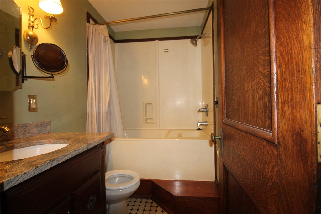 16 Balmoral Street, Unit 307 Andover, MA 01810 - Photo 9 of 10 a bathroom with a granite countertop sink toilet and shower