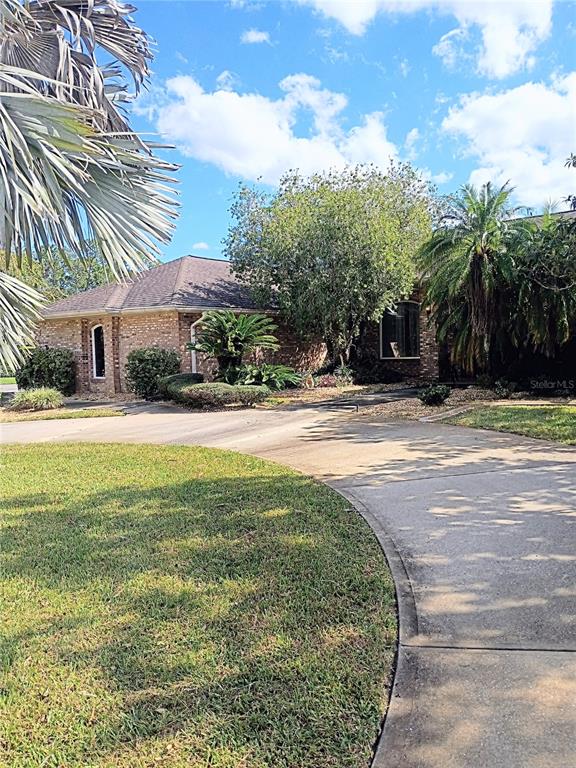a view of swimming pool with outdoor seating and covered with trees