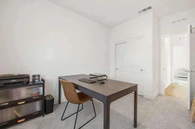 a view of a workspace with furniture