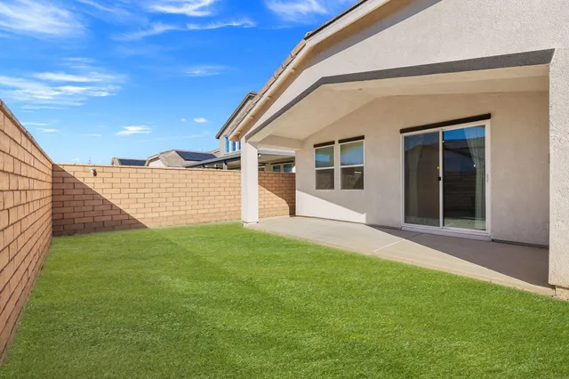 a backyard of a house with barbeque oven