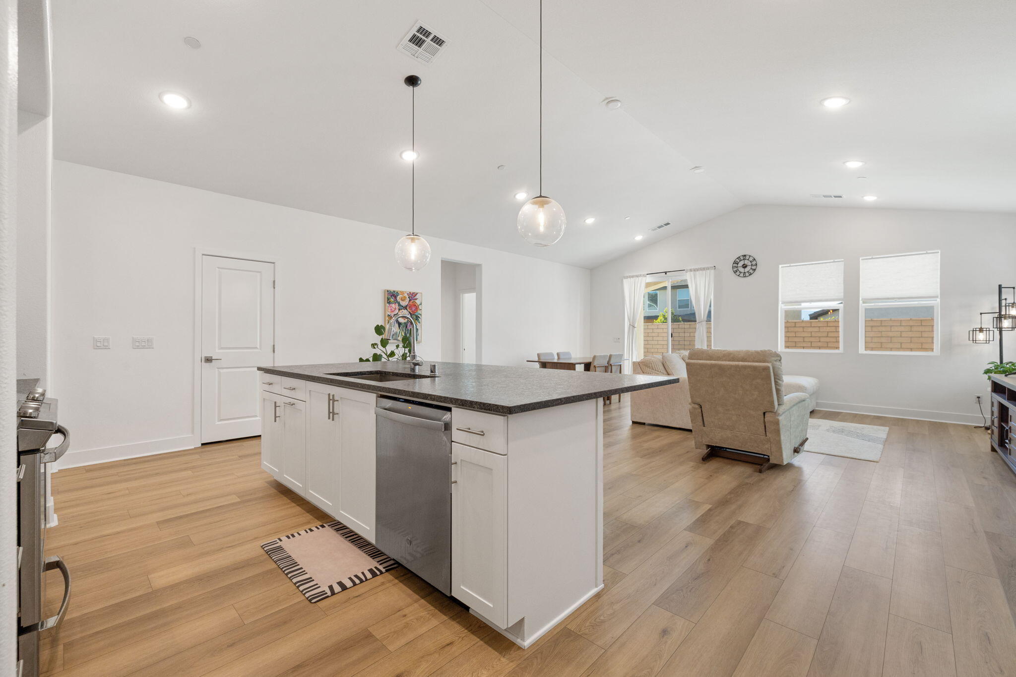 42501 Solicio Way Indio, CA 92203 - Photo 5 of 34 a large kitchen with a counter space a sink appliances and a wooden floor
