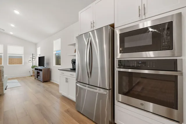 a kitchen with stainless steel appliances a refrigerator microwave and sink