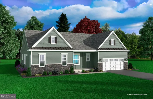 a front view of a house with a yard and trees