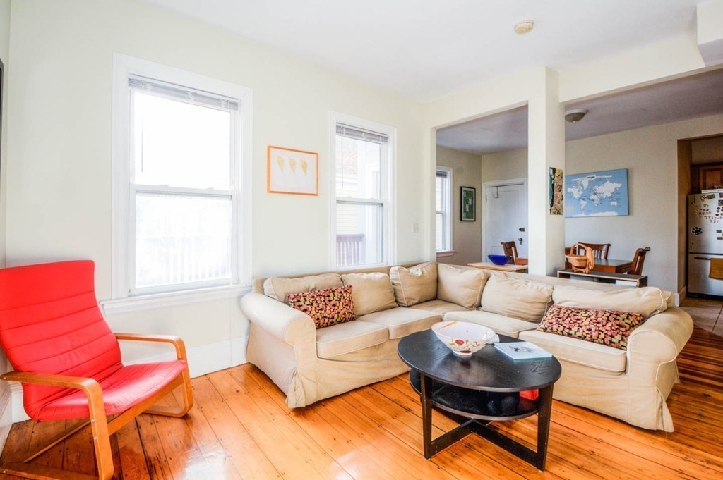 137 Paul Gore Street, Unit 2 Boston, MA 02130 - Photo 3 of 11 a living room with furniture a rug and a window