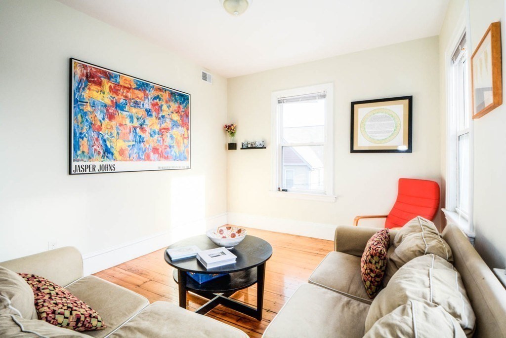 137 Paul Gore Street, Unit 2 Boston, MA 02130 - Photo 5 of 11 a living room with furniture and a painting on the wall
