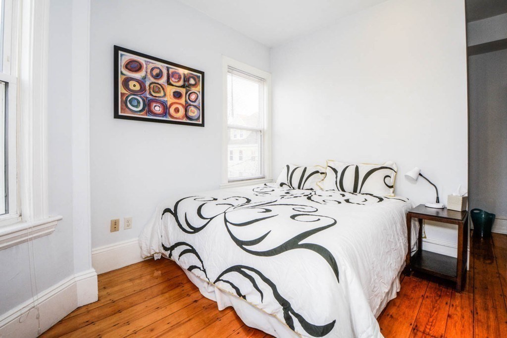 137 Paul Gore Street, Unit 2 Boston, MA 02130 - Photo 7 of 11 a bedroom with bed and a window