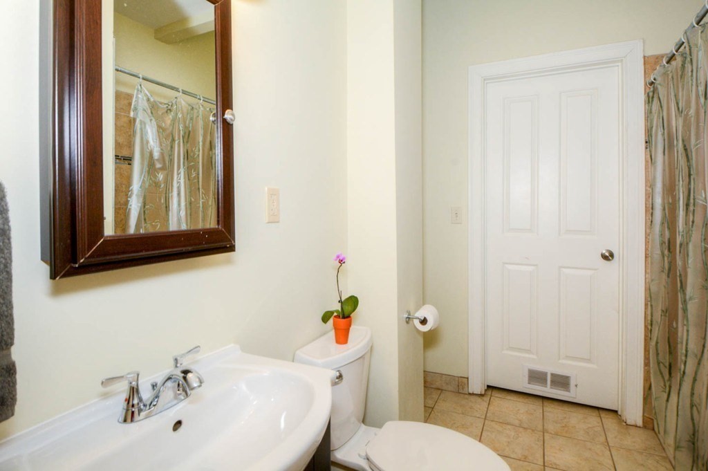 137 Paul Gore Street, Unit 2 Boston, MA 02130 - Photo 8 of 11 a bathroom with a sink a toilet and shower