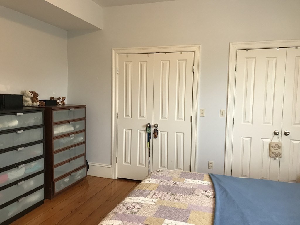 137 Paul Gore Street, Unit 2 Boston, MA 02130 - Photo 9 of 11 a view of a room with wooden floor