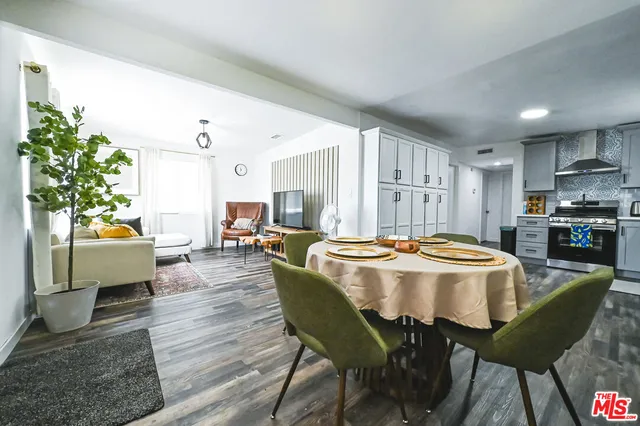 a dining room with furniture and a kitchen view