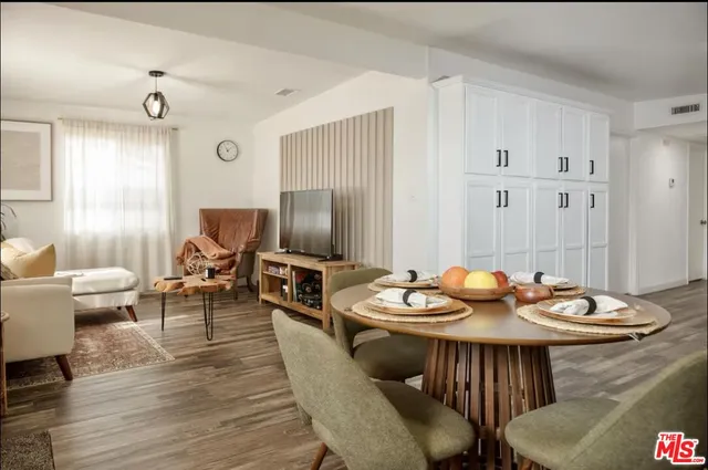 a dining room with furniture a rug and wooden floor