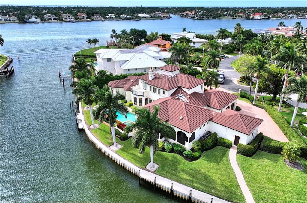 an aerial view of residential houses with outdoor space and river