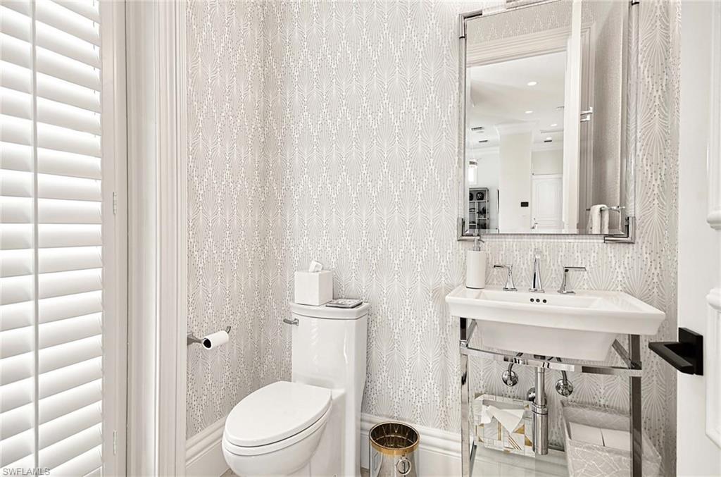 2390 Kingfish Road Naples, FL 34102 - Photo 13 of 37 a bathroom with a sink a toilet and shower