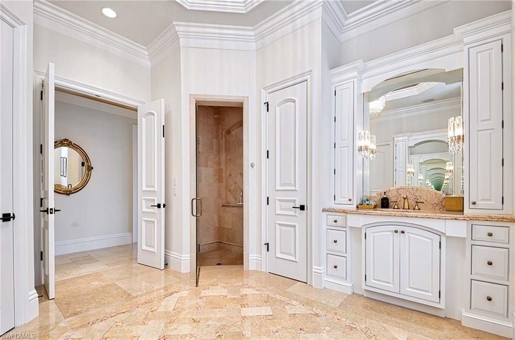 2390 Kingfish Road Naples, FL 34102 - Photo 18 of 37 a view of a bathroom with dual sinks