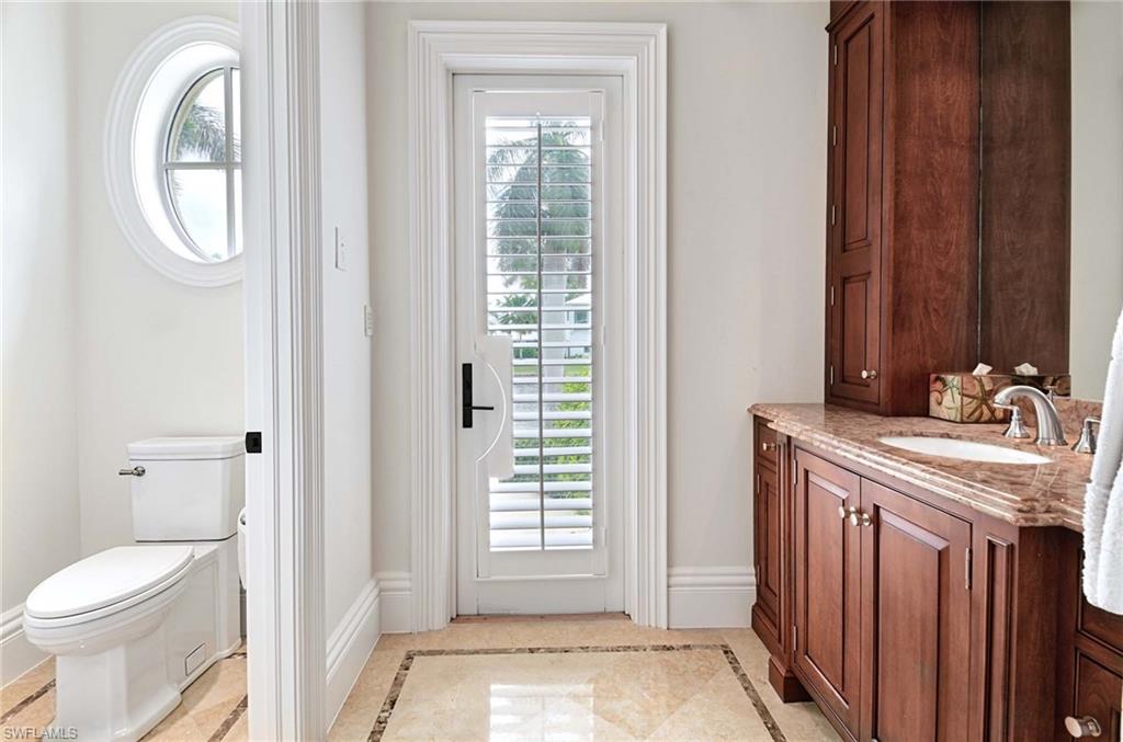 2390 Kingfish Road Naples, FL 34102 - Photo 20 of 37 a bathroom with a sink and a toilet