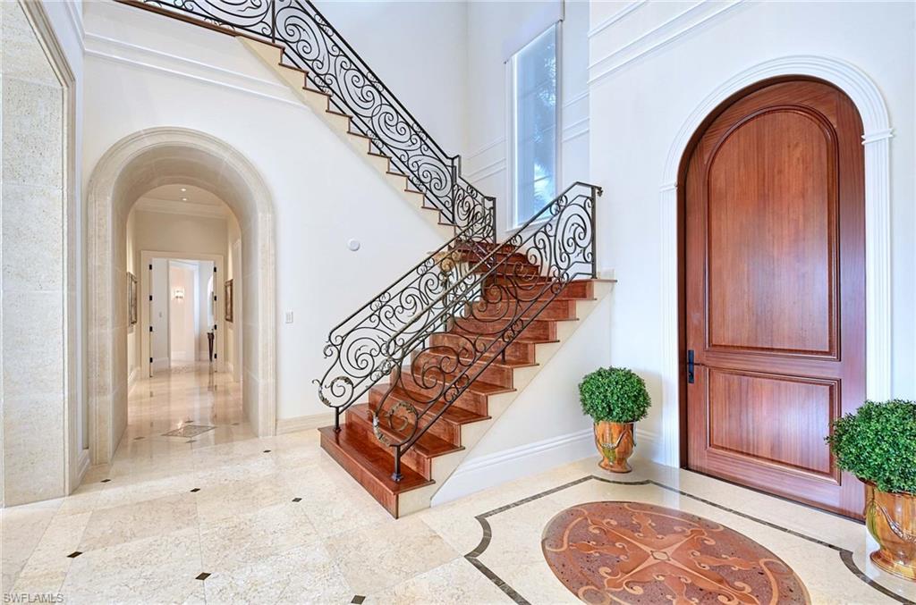 2390 Kingfish Road Naples, FL 34102 - Photo 2 of 37 a view of an entryway with wooden floor