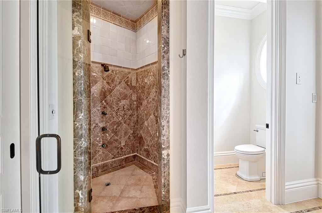 2390 Kingfish Road Naples, FL 34102 - Photo 21 of 37 a bathroom with a granite countertop shower and a toilet