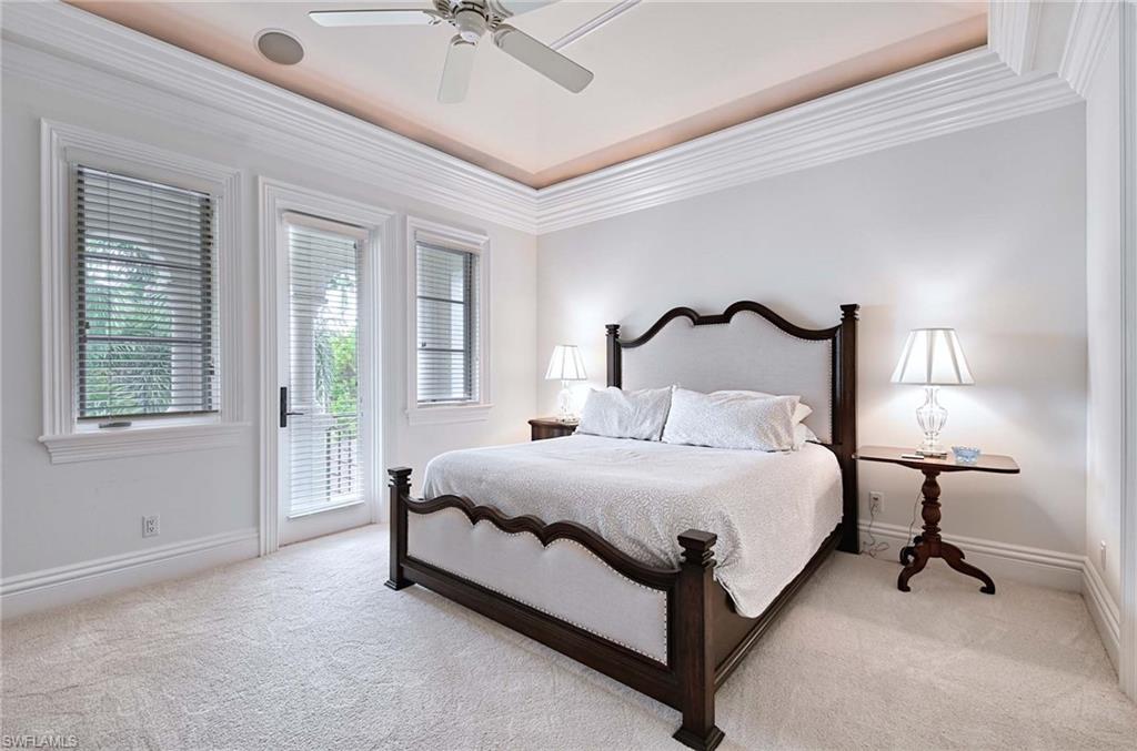 2390 Kingfish Road Naples, FL 34102 - Photo 26 of 37 a bedroom with a bed lamp and a window
