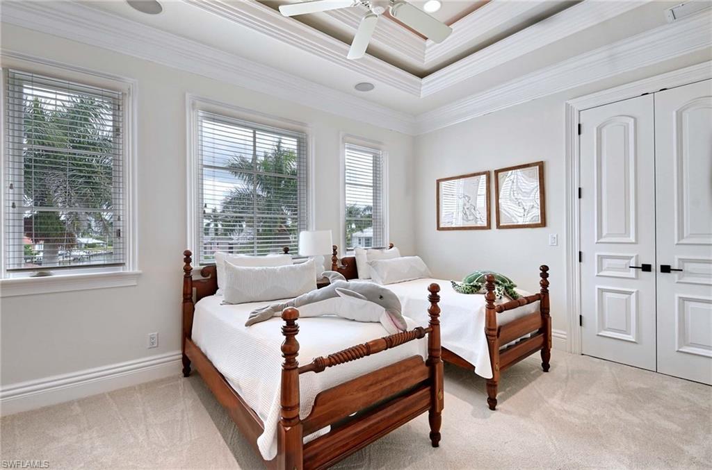 2390 Kingfish Road Naples, FL 34102 - Photo 28 of 37 a bed room with a bed and a window