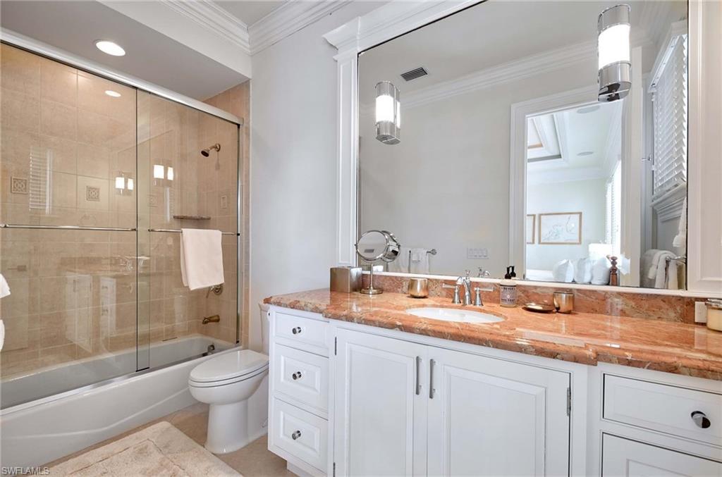 2390 Kingfish Road Naples, FL 34102 - Photo 29 of 37 a bathroom with a granite countertop sink a toilet and shower
