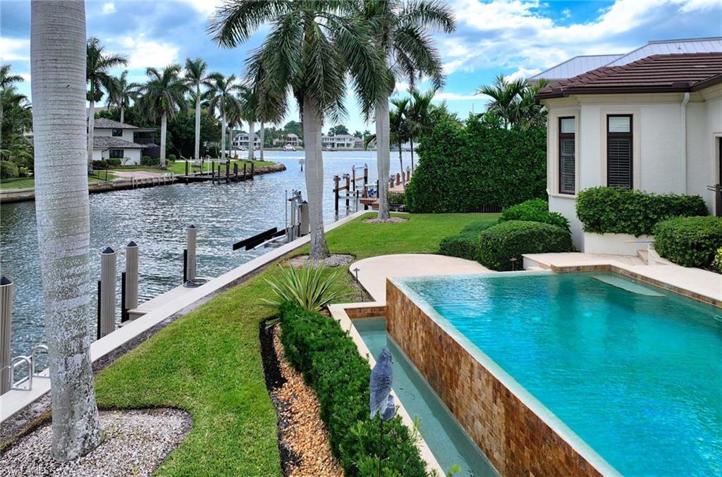 2390 Kingfish Road Naples, FL 34102 - Photo 35 of 37 a view of swimming pool with a patio