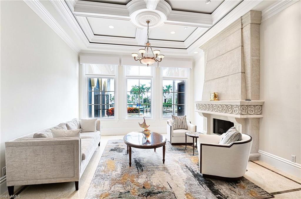 2390 Kingfish Road Naples, FL 34102 - Photo 4 of 37 a living room with furniture and a fireplace
