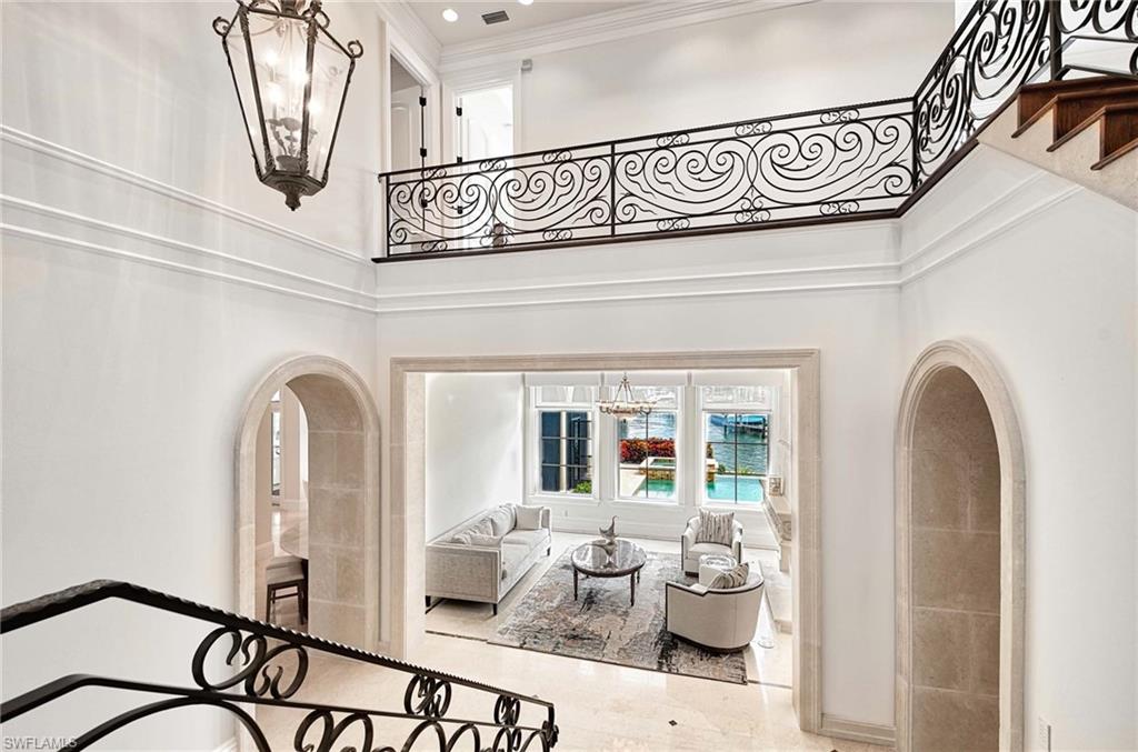 2390 Kingfish Road Naples, FL 34102 - Photo 5 of 37 a view of a hallway with a dining table chair