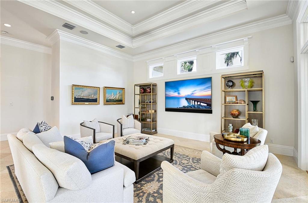 2390 Kingfish Road Naples, FL 34102 - Photo 6 of 37 a living room with furniture and a flat screen tv