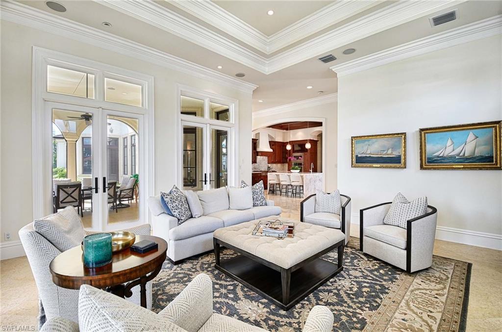 2390 Kingfish Road Naples, FL 34102 - Photo 7 of 37 a living room with furniture and a rug