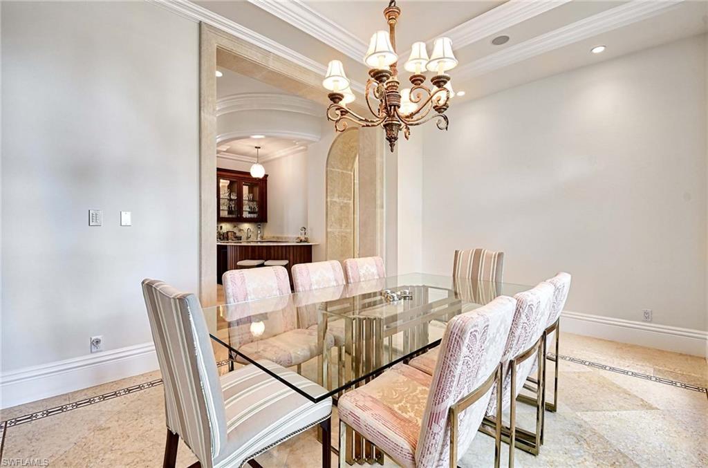 2390 Kingfish Road Naples, FL 34102 - Photo 10 of 37 a view of a dining room with furniture and a chandelier