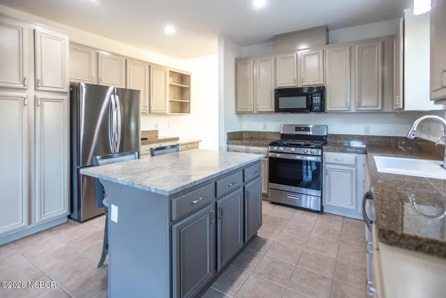 a bathroom with a toilet a sink a mirror and vanity